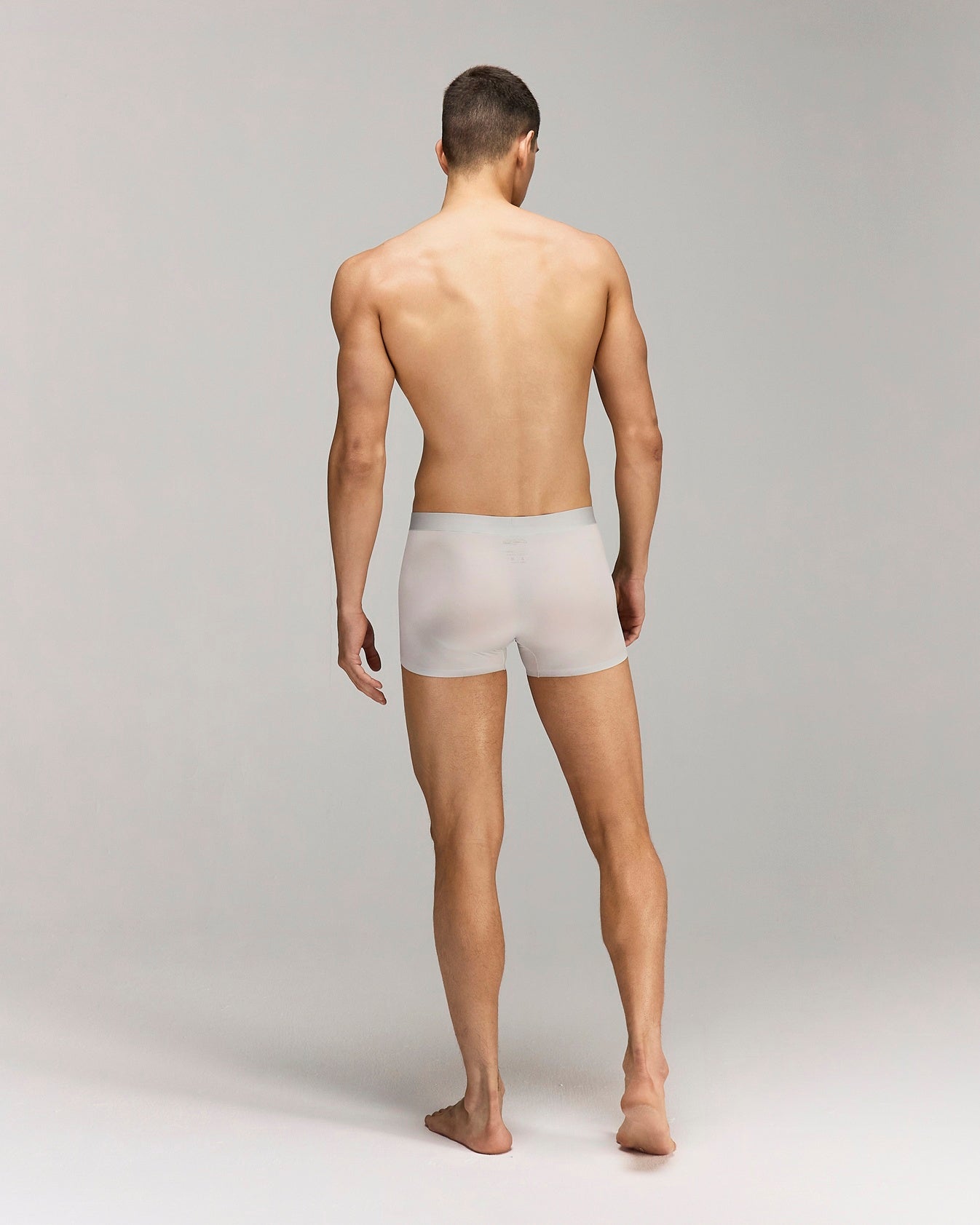 Back photo for a Model wearing Ultra Light Ice Tech Trunk in light jade.