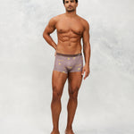 Front photo for a model wearing CottoSilk Galaxy Cotton Trunk in Brown with smooth finish and space print.