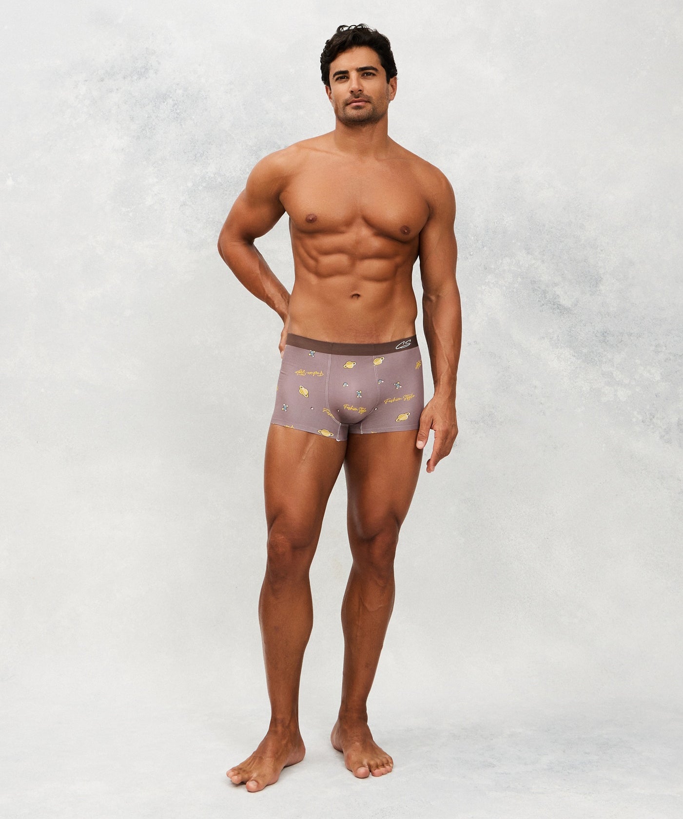 Front photo for a model wearing CottoSilk Galaxy Cotton Trunk in Brown with smooth finish and space print.