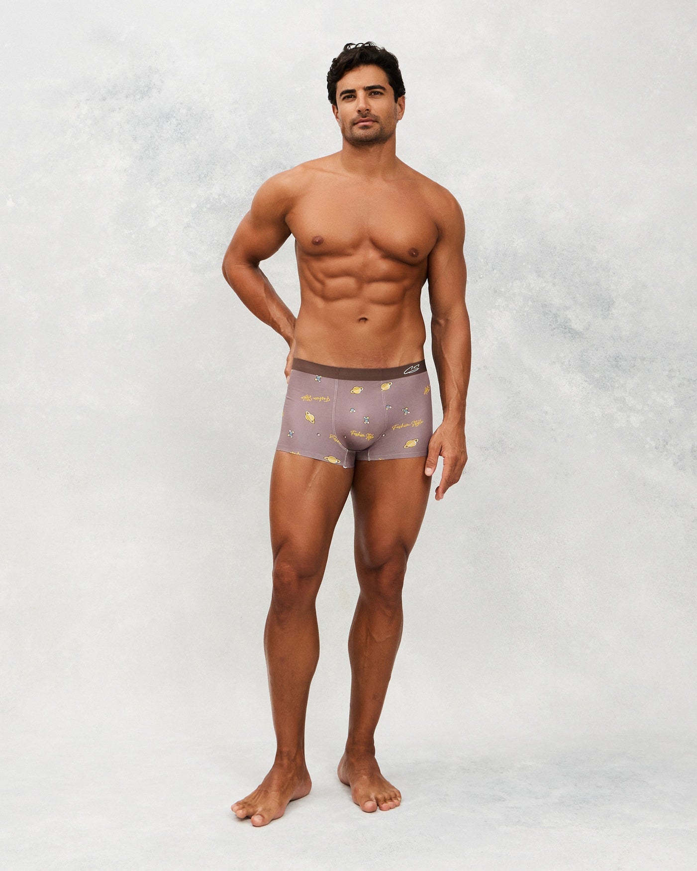 Front photo for a model wearing CottoSilk Galaxy Cotton Trunk in Brown with smooth finish and space print.