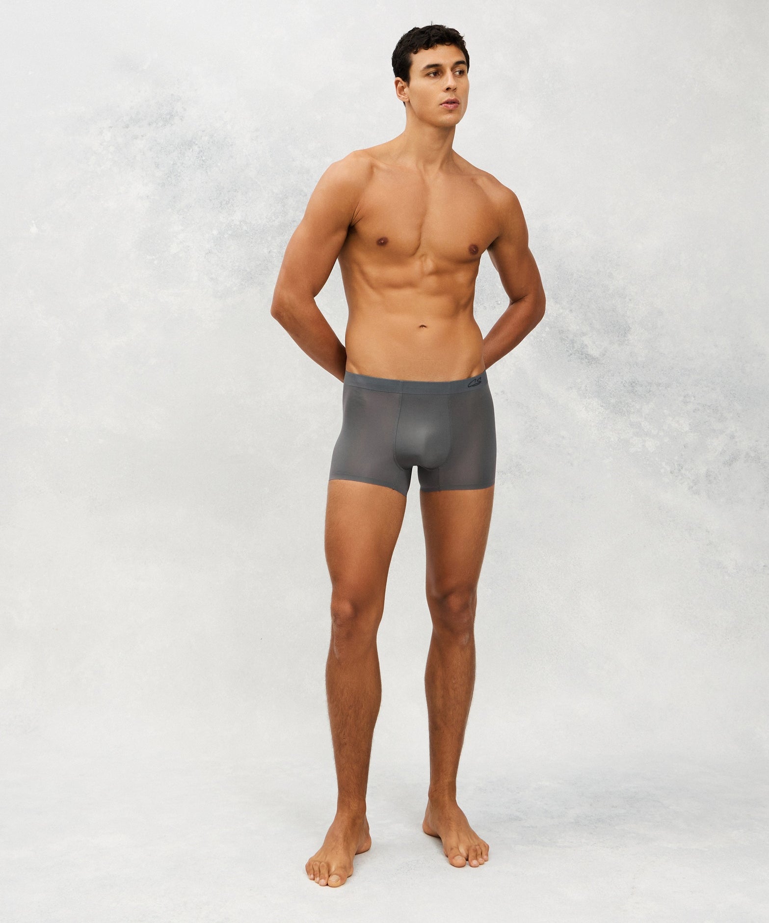Front photo for a Model wearing Ultra Light Ice Tech Trunk in dark grey.