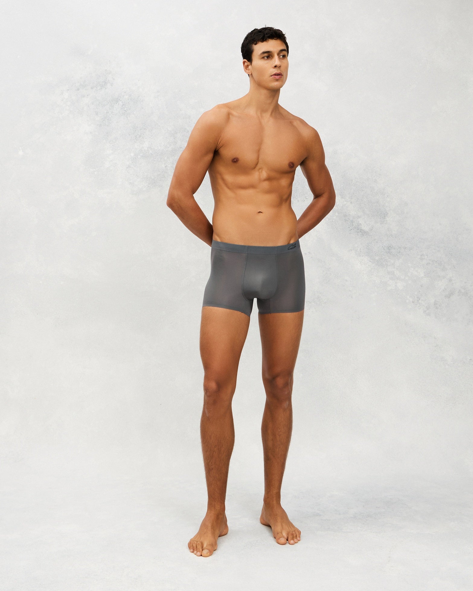 Front photo for a Model wearing Ultra Light Ice Tech Trunk in dark grey.