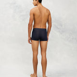 Back photo for a Model wearing Ultra Light Ice Tech Trunk in dark blue.