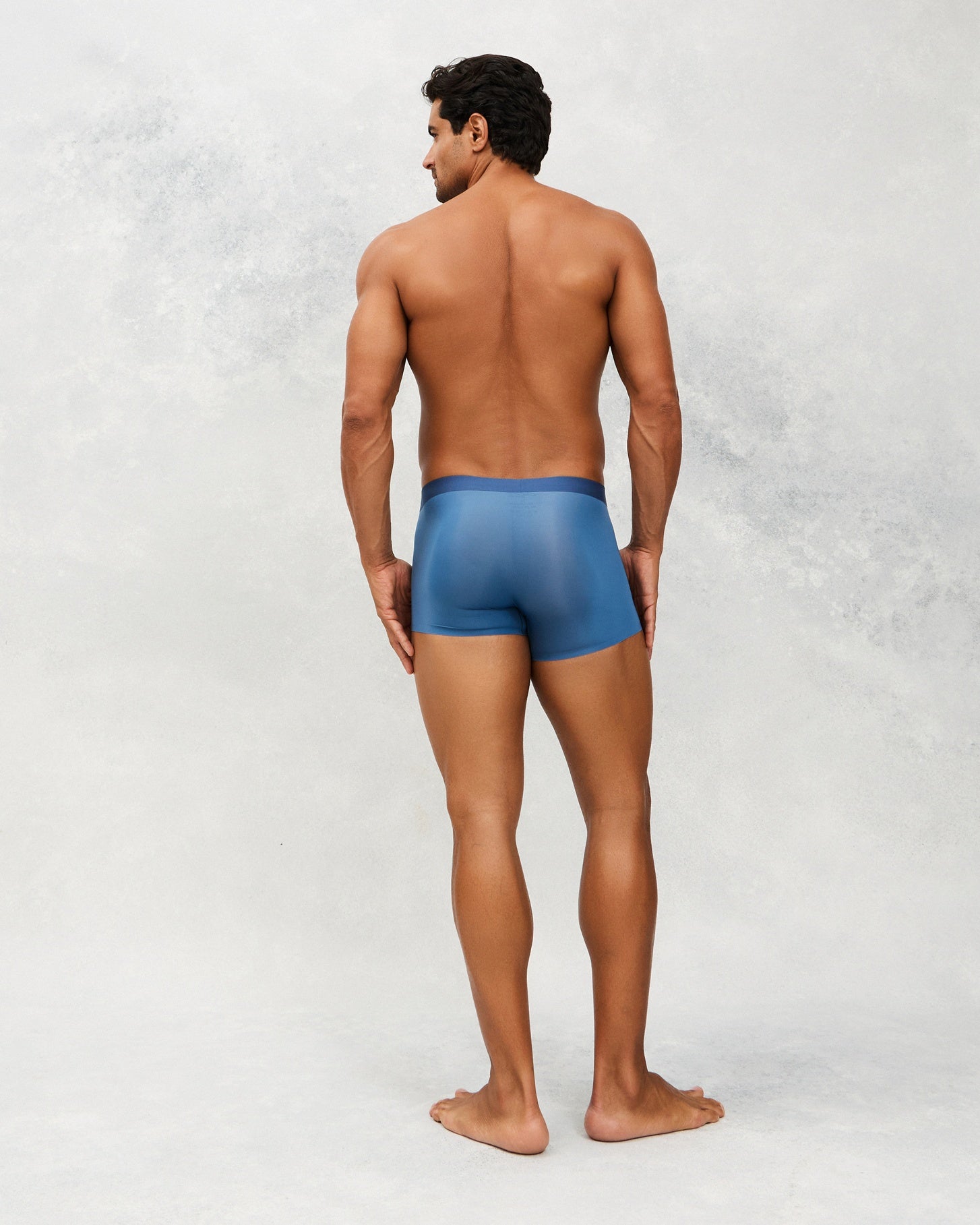Back photo for a Model wearing Ultra Light Ice Tech Trunk in blue.