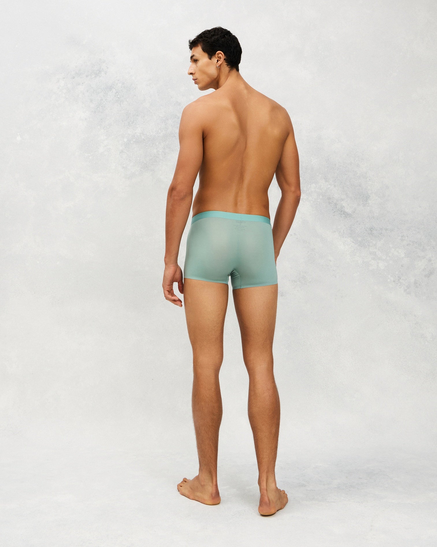 Back photo for a Model wearing Ultra Light Ice Tech Trunk in green.