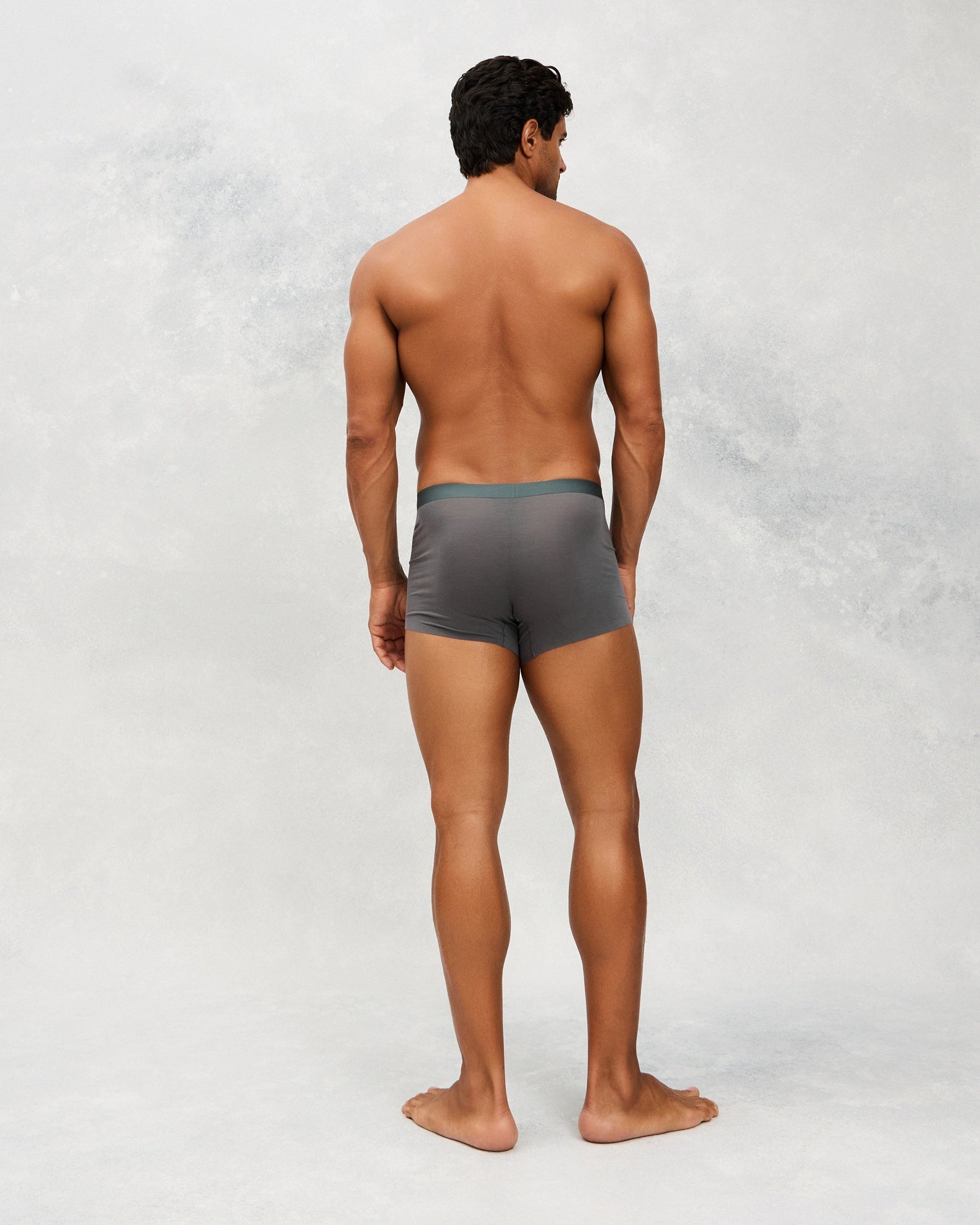 Back photo for a Model wearing Ice Tech Trunk in dark grey.
