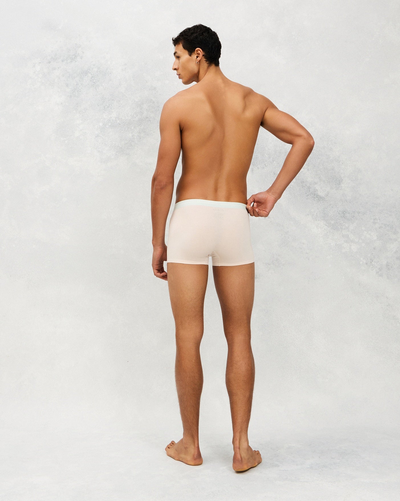 Back photo for a Model wearing Ice Tech Trunk in light orange.