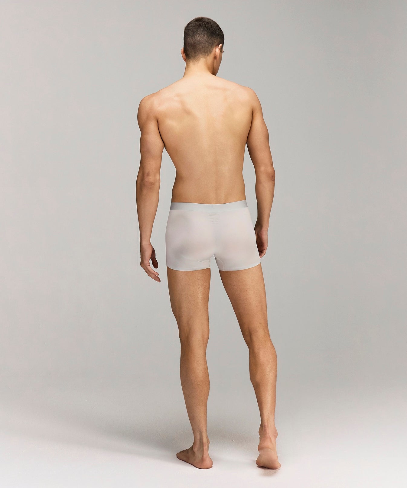 Back photo for a Model wearing Ultra Light Ice Tech Trunk in light jade.