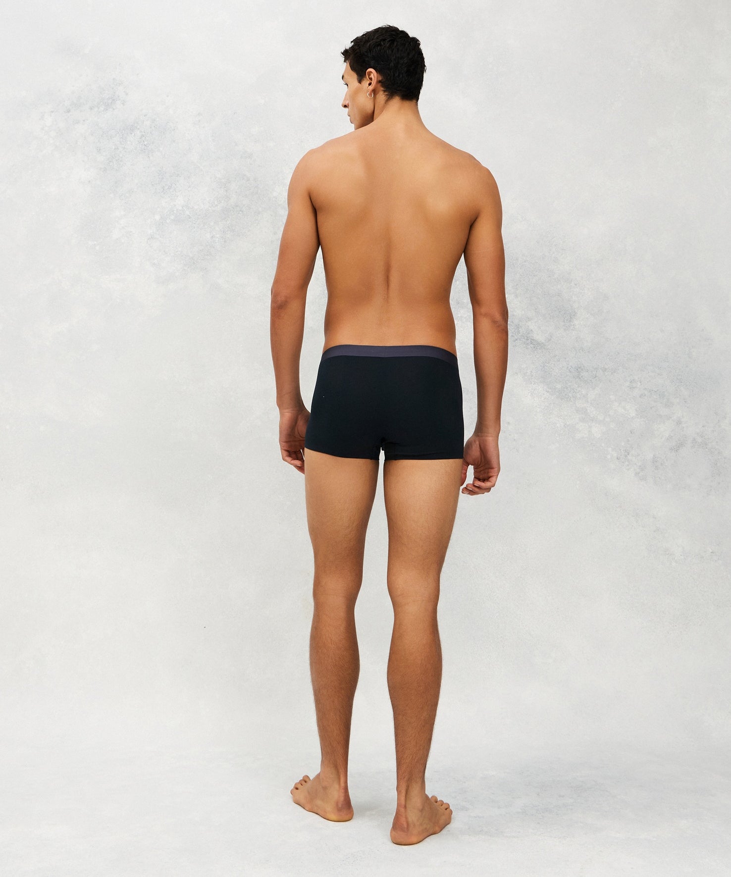 Back photo of Model wearing CottoSilk light Cotton trunk in Navy.