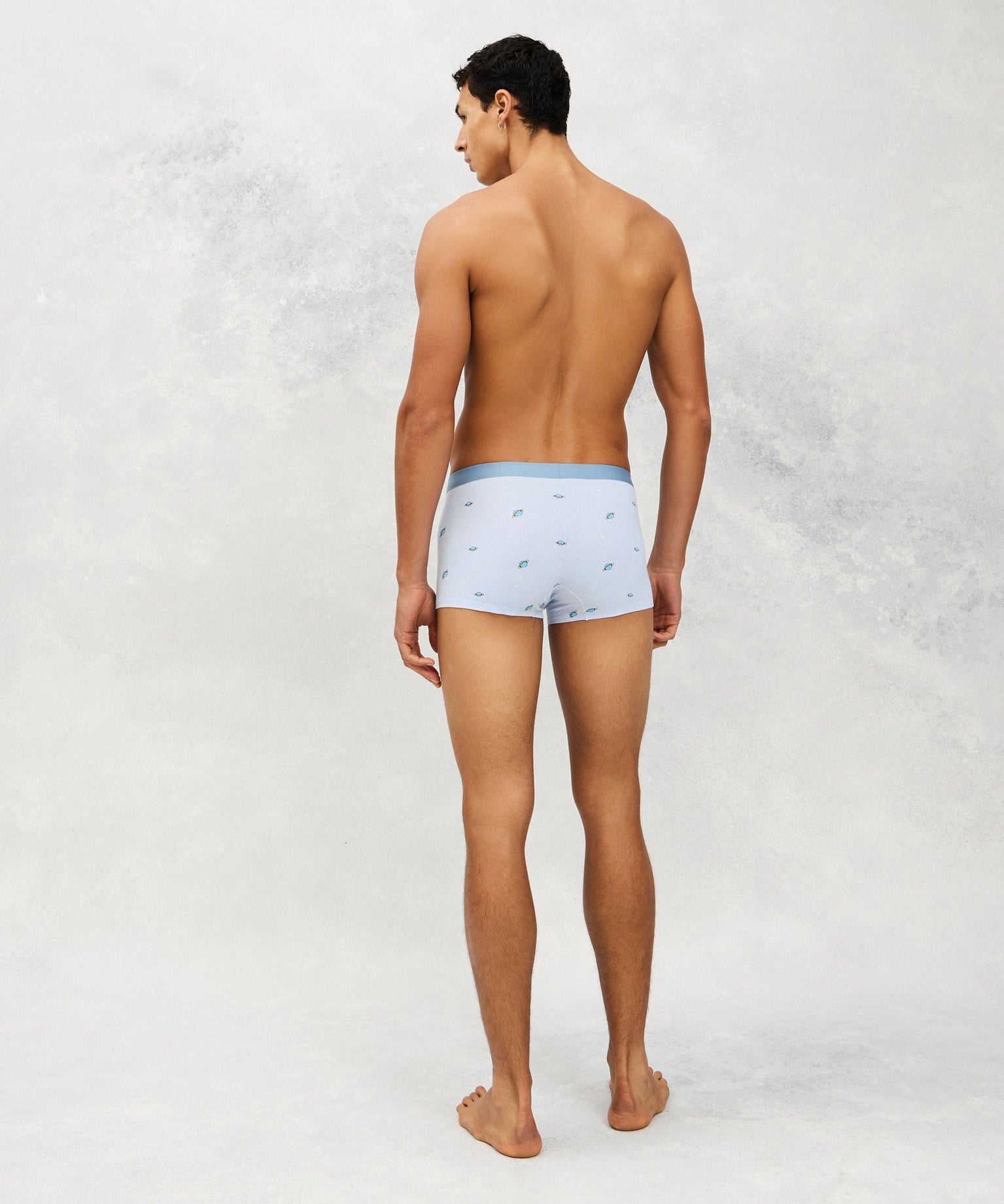 Back photo for a model wearing CottoSilk Galaxy Cotton Trunk in Light Blue with smooth finish and space print.