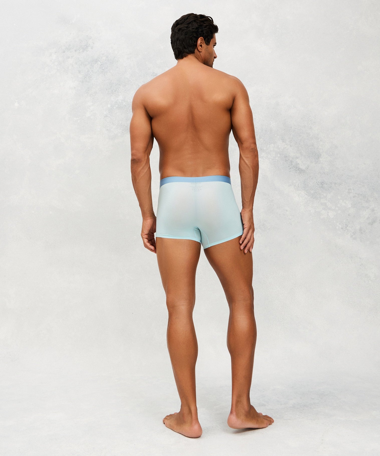  Back photo for a Model wearing Ultra Light Ice Tech Trunk in light blue.