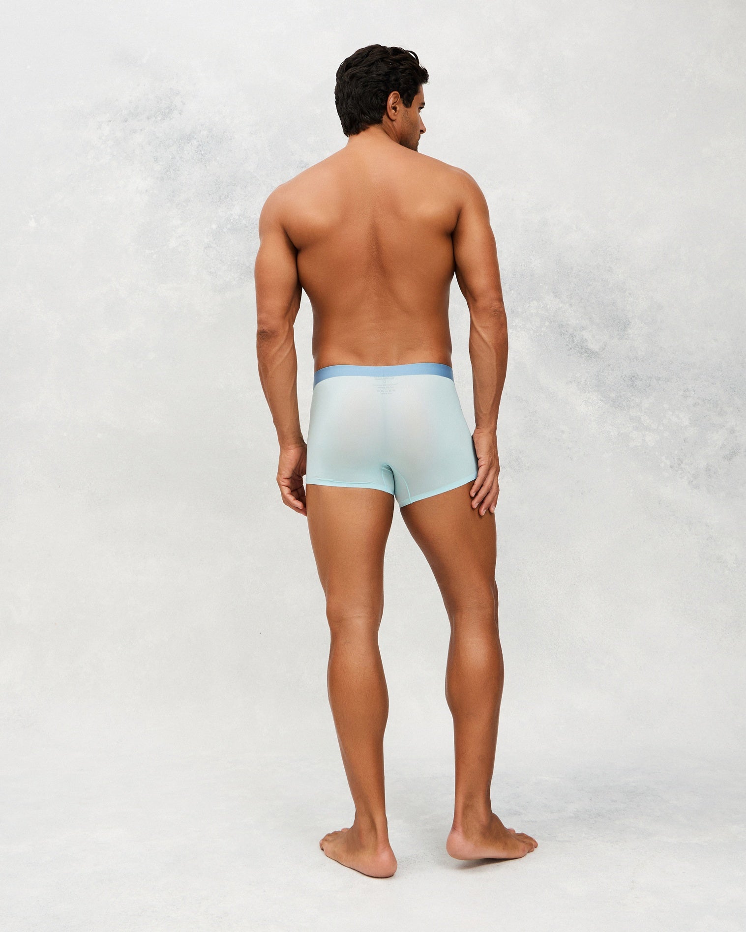  Back photo for a Model wearing Ultra Light Ice Tech Trunk in light blue.