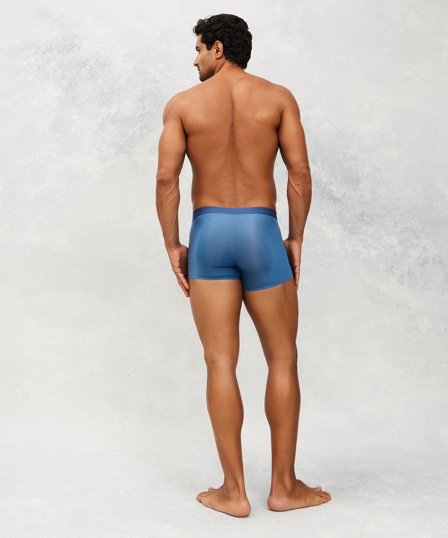 Back photo for a Model wearing Ultra Light Ice Tech Trunk in blue.