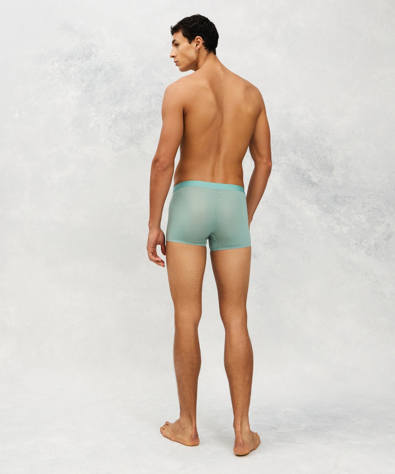 Back photo for a Model wearing Ultra Light Ice Tech Trunk in green.