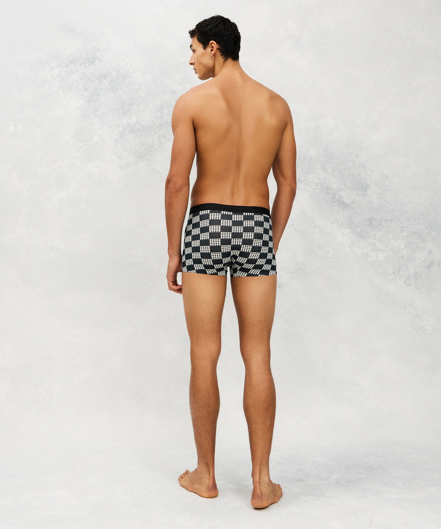 Back photo for a Model wearing Grid Modal Trunk with geometric pattern in black.