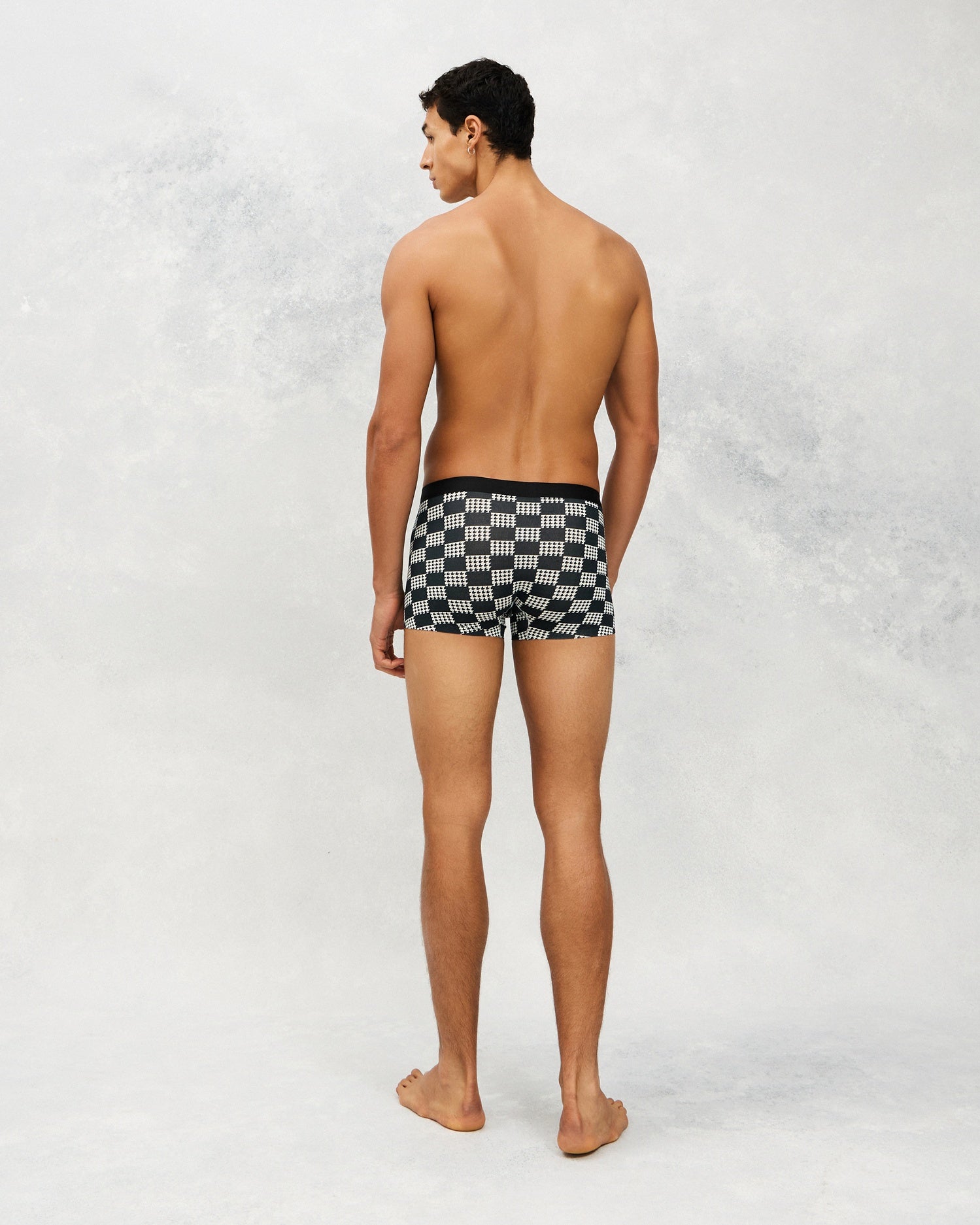 Back photo for a Model wearing Grid Modal Trunk with geometric pattern in black.