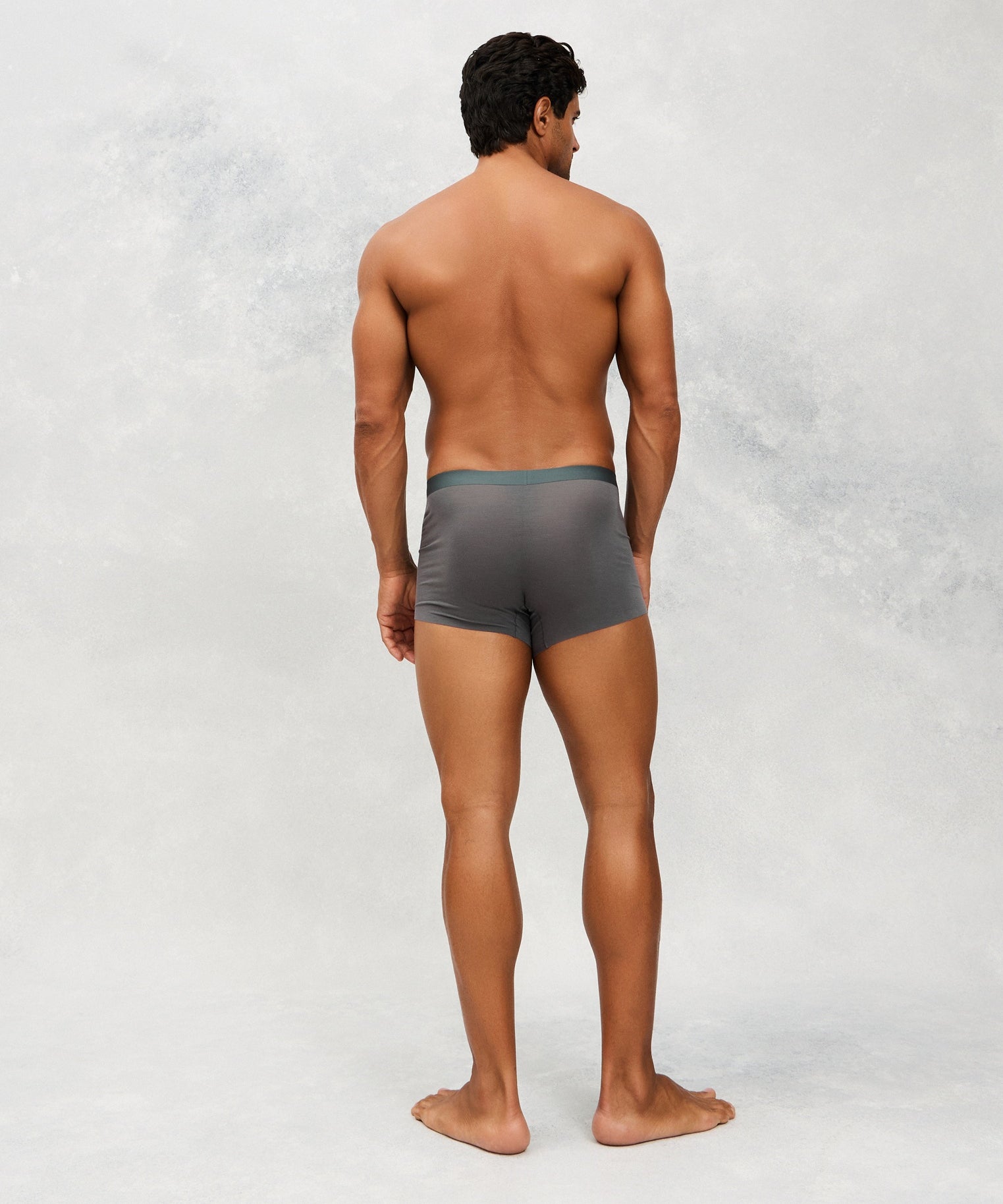 Back photo for a Model wearing Ice Tech Trunk in dark grey.