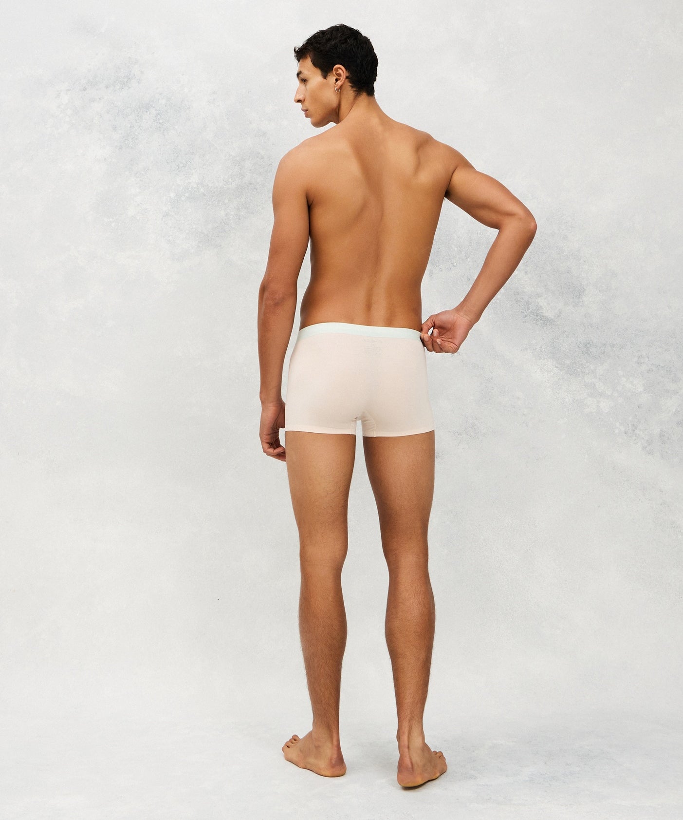Back photo for a Model wearing Ice Tech Trunk in light orange.