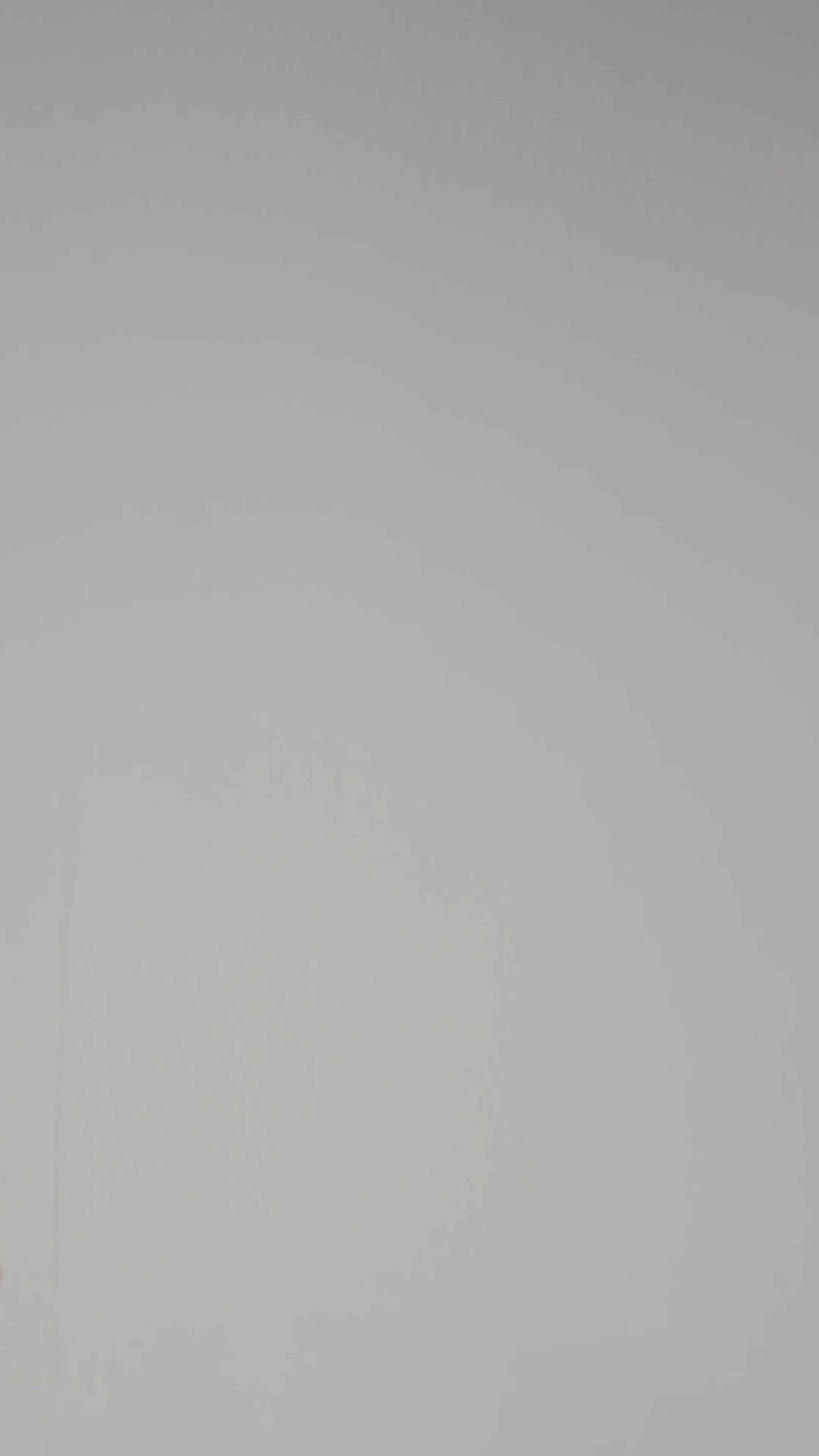 A model wearing Luxury Soft Modal Undershirt with V-neck in grey showing its details and laser cut finish.