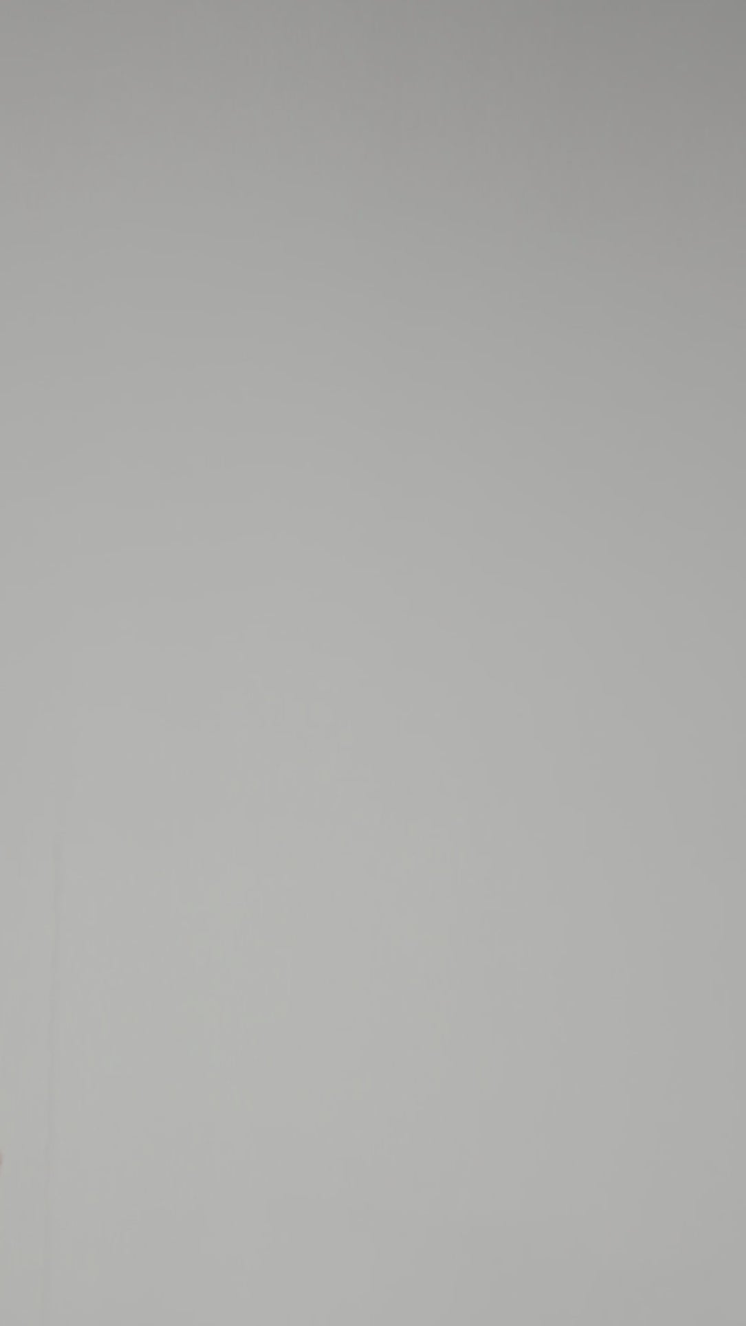 A model wearing Luxury Soft Modal Undershirt with V-neck in grey showing its details and laser cut finish.