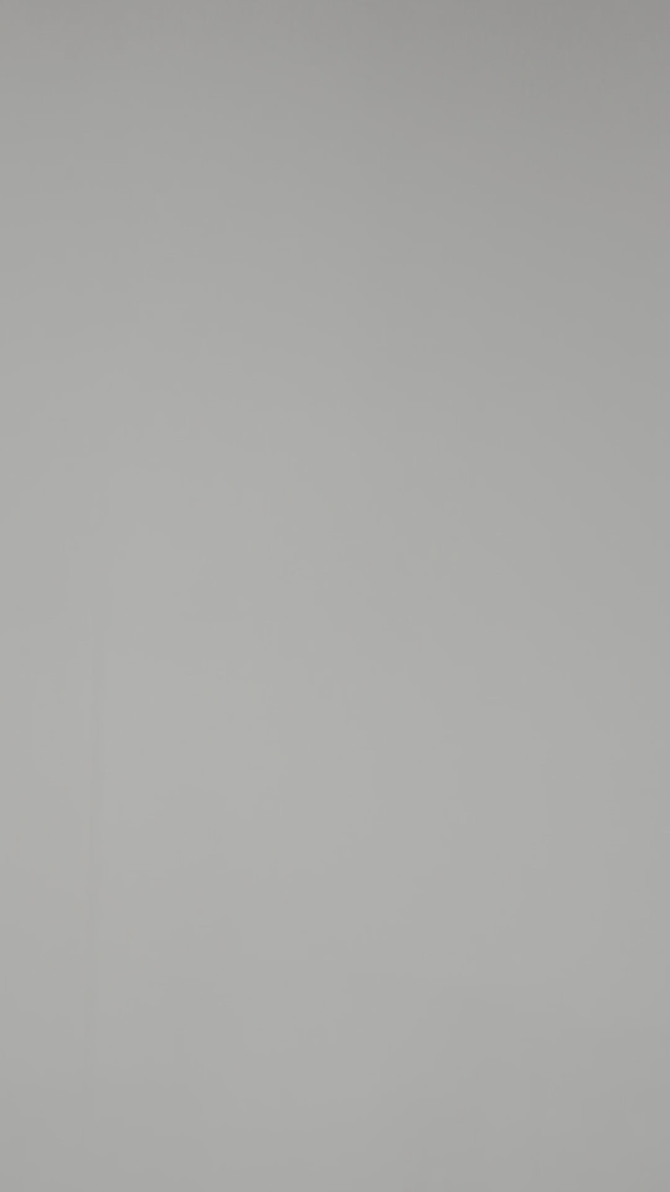 A model wearing Luxury Soft Modal Undershirt with V-neck in White showing its details and laser cut finish.