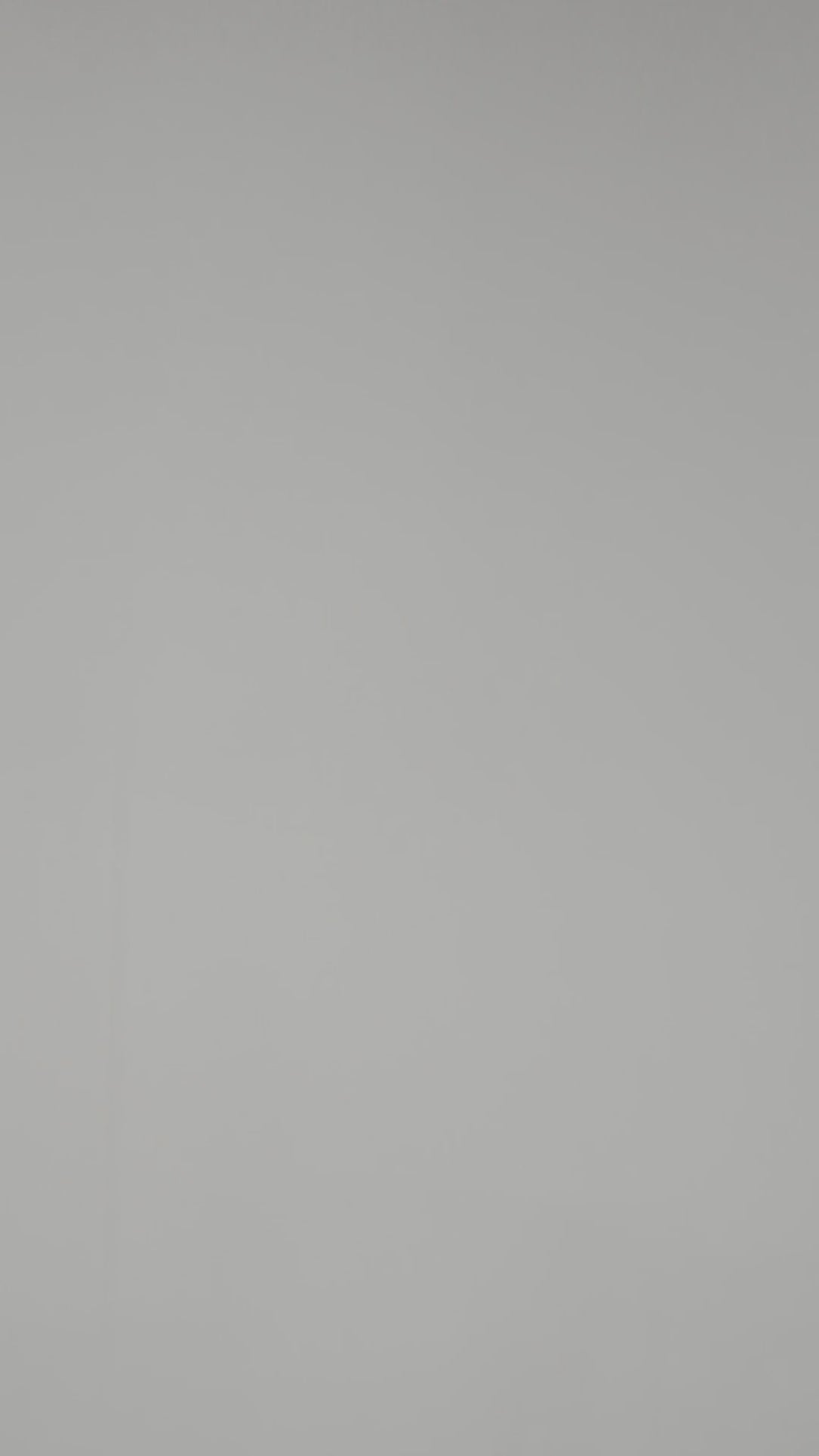 A model wearing Luxury Soft Modal Undershirt with V-neck in White showing its details and laser cut finish.