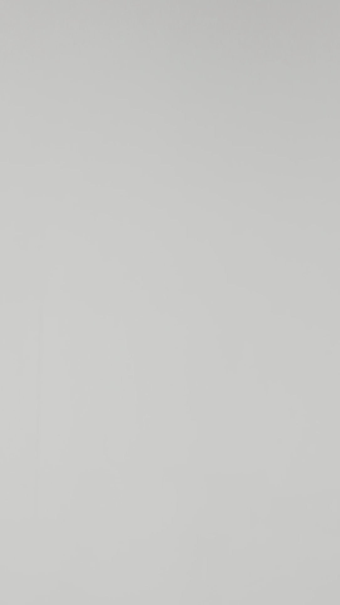 A model wearing Luxury Soft Modal Undershirt with V-neck in black showing its details and laser cut finish.